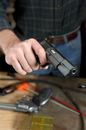 simsearch:700-00546343,k - Man Holding Handgun after Cleaning Stock Photo - Rights-Managed, Code: 700-00546335