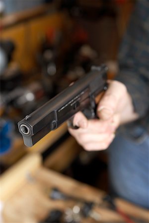 simsearch:700-00546343,k - Close-up of Man's Hand Holding Handgun Stock Photo - Rights-Managed, Code: 700-00546336