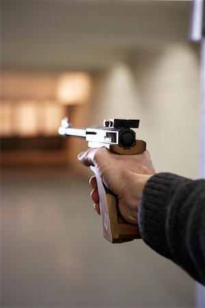 simsearch:700-00546343,k - Man's Hand Holding Handgun and Aiming at Target Stock Photo - Rights-Managed, Code: 700-00546339