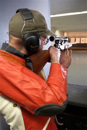 simsearch:700-00546343,k - Man Aiming with Scope of Rifle in Firing Booth Stock Photo - Rights-Managed, Code: 700-00546345