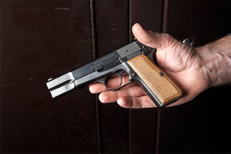 simsearch:700-00546343,k - Close-up of Man's Hand Holding Handgun Stock Photo - Rights-Managed, Code: 700-00546347