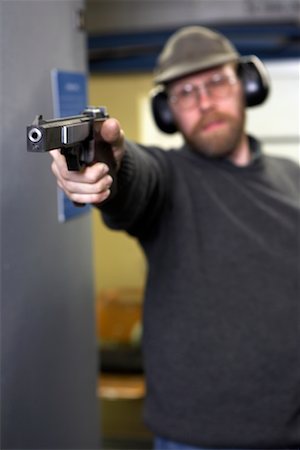 simsearch:700-00546343,k - Man Shooting Handgun in Firing Booth Stock Photo - Rights-Managed, Code: 700-00546342