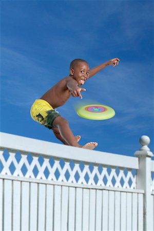 simsearch:700-00520129,k - Boy Throwing Frisbee over Fence Stock Photo - Rights-Managed, Code: 700-00546444
