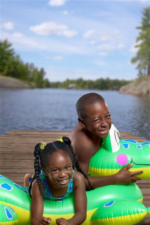 Boy and Girl with Inflatable Toy On Dock Stock Photo - Rights-Managed, Code: 700-00546448