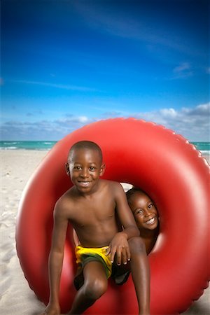 Boy and Girl with Inner Tube on Beach Stock Photo - Rights-Managed, Code: 700-00546441