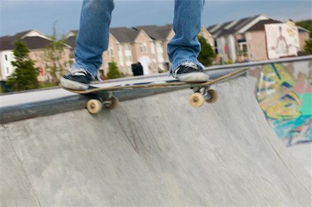 Man's Legs Standing on Skateboard Stock Photo - Rights-Managed, Code: 700-00546629