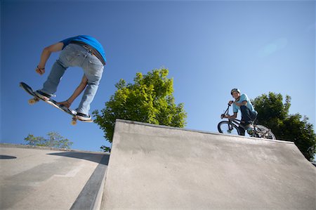 Skateboarder and Cyclist on Ramp Stock Photo - Rights-Managed, Code: 700-00546678