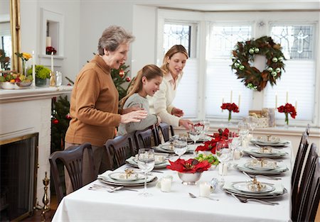 Grandmother, Mother and Daughter Setting Table for Christmas Dinner Stock Photo - Rights-Managed, Code: 700-00547132