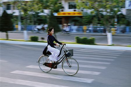 riding bike female basket - Woman on Bicycle, Can Tho, Vietnam Stock Photo - Rights-Managed, Code: 700-00555617