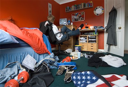 Boy Sitting in Messy Room Stock Photo - Rights-Managed, Code: 700-00550294