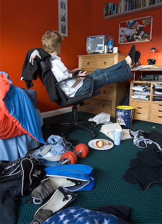 Boy Sitting in Messy Room Stock Photo - Rights-Managed, Code: 700-00550296