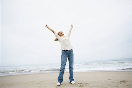 simsearch:700-00377960,k - Woman Cheering on Beach Stock Photo - Rights-Managed, Code: 700-00550375