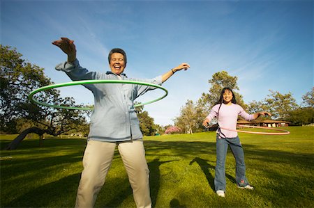 Grandmother and Granddaughter Hulahooping Foto de stock - Con derechos protegidos, Código: 700-00550609