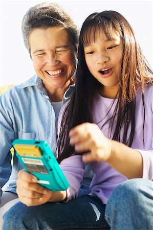 simsearch:700-00046927,k - Grandmother Watching Granddaughter Play Video Game Stock Photo - Rights-Managed, Code: 700-00550618