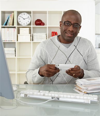 simsearch:700-00045560,k - Man in Home Office with Stack of Bills Stock Photo - Rights-Managed, Code: 700-00560860