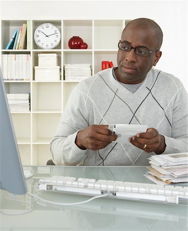 simsearch:700-00045560,k - Man in Home Office with Stack of Bills Stock Photo - Rights-Managed, Code: 700-00560861