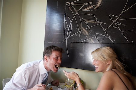 painting of people in a restaurant - Woman Feeding Man in Restaurant Stock Photo - Rights-Managed, Code: 700-00561325