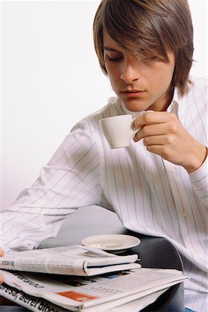 simsearch:700-00561804,k - Young Man Drinking Coffee and Reading Newspaper Stock Photo - Rights-Managed, Code: 700-00561808