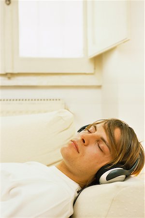 Young Man With Headphones Listening to Music Stock Photo - Rights-Managed, Code: 700-00561817