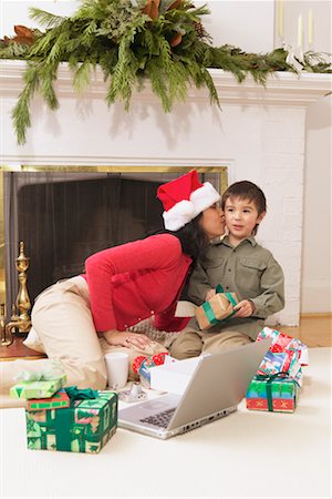 simsearch:700-00795365,k - Boy Putting Santa Hat on His Mother Stock Photo - Rights-Managed, Code: 700-00591491
