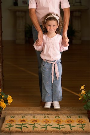 door welcome doormat - Mother and Daughter Standing at Front Door Stock Photo - Rights-Managed, Code: 700-00592993