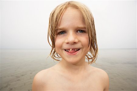 Boy Wiggling Loose Tooth Stock Photo - Rights-Managed, Code: 700-00609737