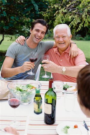 simsearch:673-02139604,k - Father and Adult Son Drinking Wine at Outdoor Family Dinner Stock Photo - Rights-Managed, Code: 700-00610200