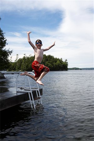 Boy Jumping into Lake Rosseau, Muskoka, Ontario, Canada Stock Photo - Rights-Managed, Code: 700-00611097