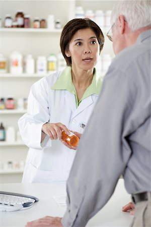 person buying pills at chemist - Pharmacist Helping Customer Stock Photo - Rights-Managed, Code: 700-00623055