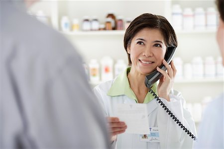 person buying pills at chemist - Pharmacist Helping Customers Stock Photo - Rights-Managed, Code: 700-00623065