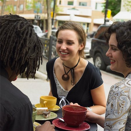 Three Young People Having Coffee At A Sidewalk Cafe Stock Photo - Rights-Managed, Code: 700-00634099