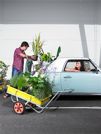Woman Watching Man Loading Plants Into Trunk of Car Stock Photo - Rights-Managed, Code: 700-00644040
