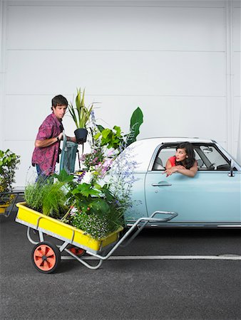 Woman Watching Man Loading Plants Into Trunk of Car Stock Photo - Rights-Managed, Code: 700-00644042