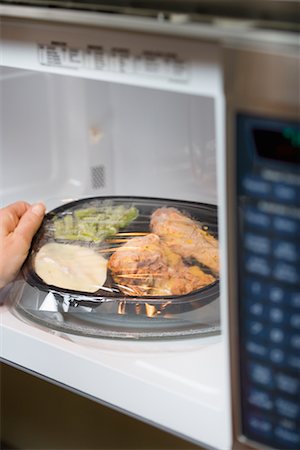 Heating up TV Dinner in Microwave Stock Photo - Rights-Managed, Code: 700-00644318