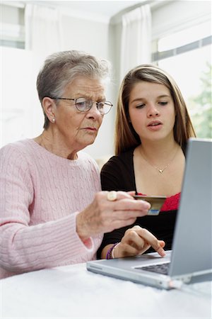 Grandmother and Granddaughter Shopping Online Foto de stock - Con derechos protegidos, Código: 700-00649998