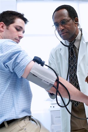 simsearch:700-00616627,k - Doctor Checking Patient's Blood Pressure Stock Photo - Rights-Managed, Code: 700-00661009