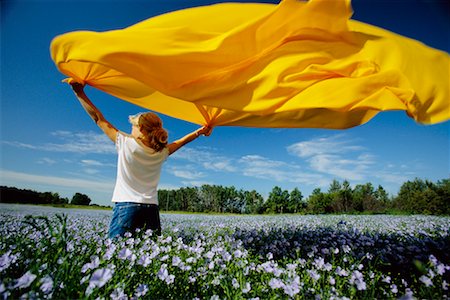 Girl in Flax Field, Holding Yellow Cloth Stock Photo - Rights-Managed, Code: 700-00661180