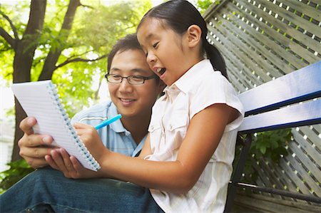 Father Watching Daughter Write Stock Photo - Rights-Managed, Code: 700-00686881