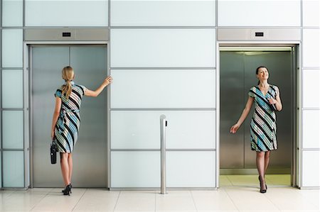 simsearch:700-00681397,k - Two Businesswomen at Elevators Wearing Same Dress Stock Photo - Rights-Managed, Code: 700-00681400