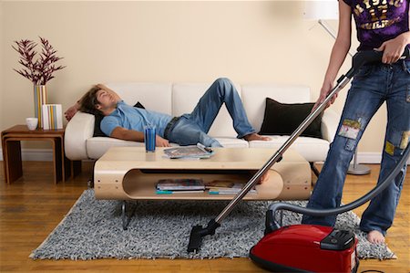 simsearch:700-00683334,k - Woman Vacuuming while Man Sleeps on Sofa Stock Photo - Rights-Managed, Code: 700-00683335