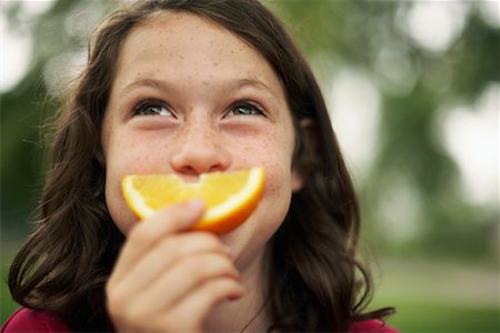 simsearch:700-00033360,k - Girl Eating Orange Stock Photo - Rights-Managed, Code: 700-00695619