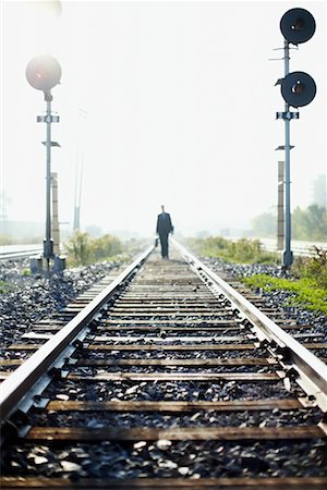 Businessman Walking along Train Tracks Stock Photo - Rights-Managed, Code: 700-00695820