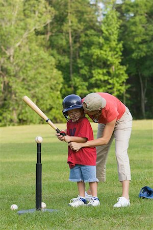 Mother Helping Son Play T-Ball Stock Photo - Rights-Managed, Code: 700-00711629