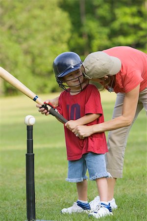 Mother Helping Son Play T-Ball Stock Photo - Rights-Managed, Code: 700-00711630