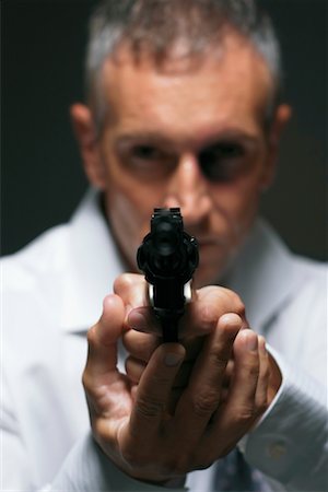 simsearch:700-00546343,k - Man Aiming Gun Stock Photo - Rights-Managed, Code: 700-00748042