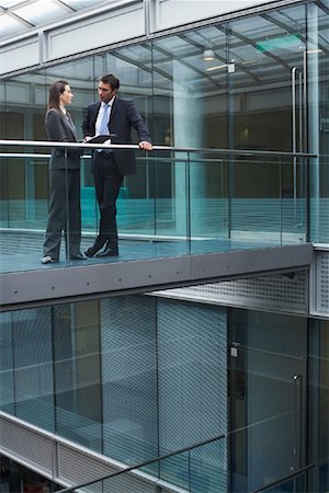side view railings glass - Business People Standing in Walkway of Office Building Stock Photo - Rights-Managed, Code: 700-00748542