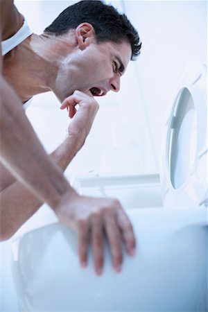 puking toilet - Man Inducing Vomit Stock Photo - Rights-Managed, Code: 700-00782045