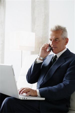 simsearch:700-03058969,k - Businessman on Cellular Phone Using Laptop Stock Photo - Rights-Managed, Code: 700-00782236