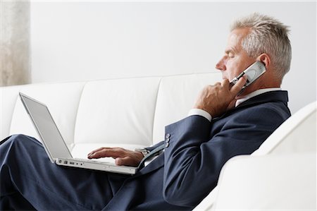simsearch:700-03058969,k - Businessman on Cellular Phone Using Laptop Stock Photo - Rights-Managed, Code: 700-00782238