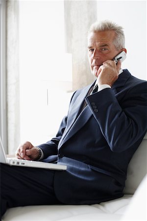 simsearch:700-03058969,k - Businessman Using Cellular Phone and Laptop Stock Photo - Rights-Managed, Code: 700-00782231